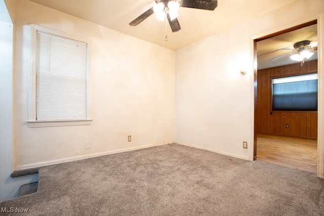 carpeted spare room featuring ceiling fan