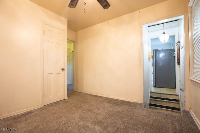 empty room with carpet floors and ceiling fan