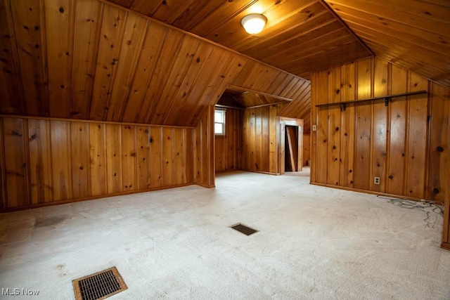 bonus room with wooden ceiling, lofted ceiling, wooden walls, and light carpet