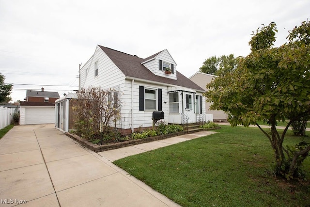 cape cod-style house featuring a front yard and a garage