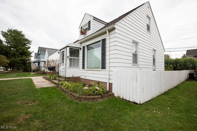 view of home's exterior with a lawn