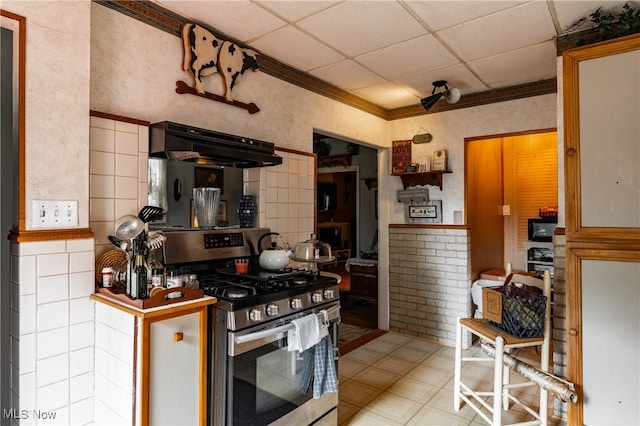 kitchen with ornamental molding, stainless steel gas range, a paneled ceiling, and extractor fan