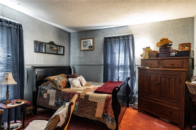 bedroom featuring carpet floors and a textured ceiling