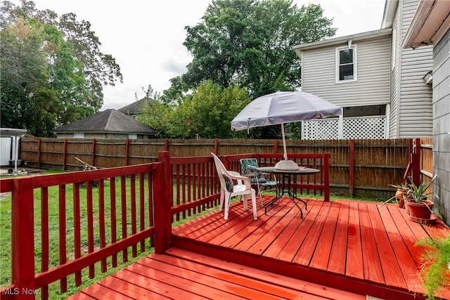 wooden deck featuring a yard