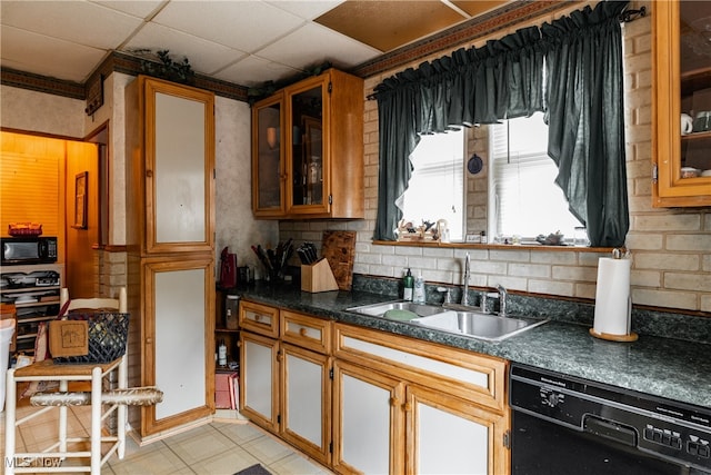 kitchen featuring a drop ceiling, black appliances, and sink