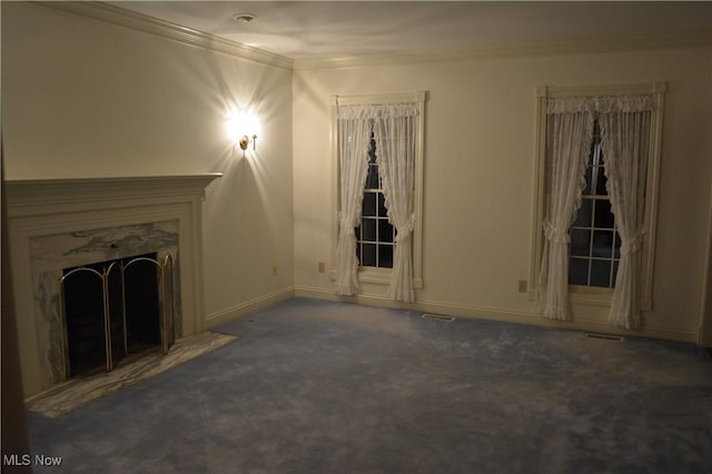 unfurnished living room with a fireplace, ornamental molding, and dark colored carpet