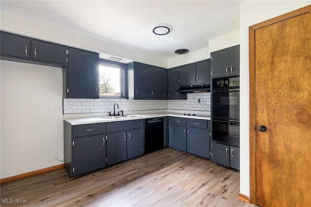 kitchen with light hardwood / wood-style floors, backsplash, sink, and black appliances