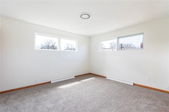 spare room featuring baseboard heating and carpet flooring