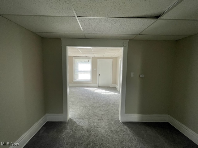 corridor with carpet and a drop ceiling