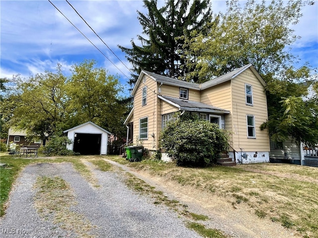 view of home's exterior featuring a garage and an outbuilding