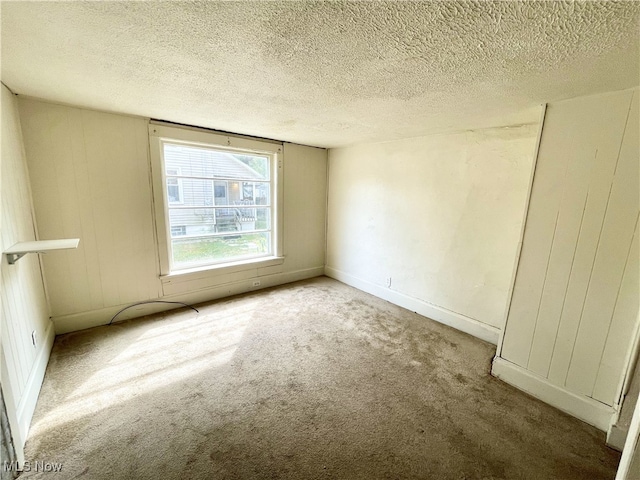 unfurnished bedroom with a textured ceiling and carpet flooring