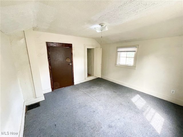 unfurnished bedroom featuring a textured ceiling and carpet floors