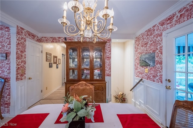 dining area featuring crown molding and an inviting chandelier