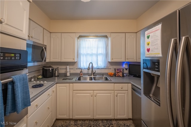 kitchen with backsplash, white cabinetry, sink, and appliances with stainless steel finishes