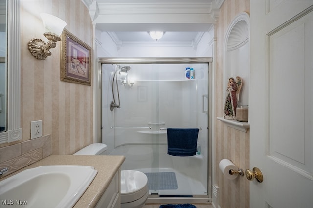 bathroom featuring crown molding, vanity, a shower with shower door, and toilet