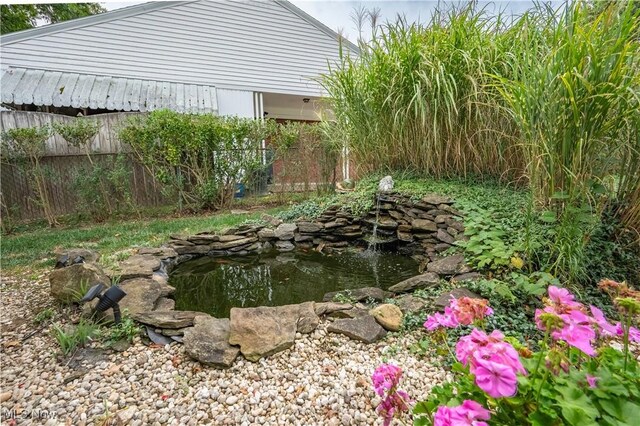 view of yard with a small pond