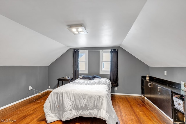 bedroom with hardwood / wood-style flooring and vaulted ceiling