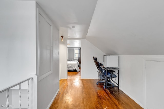 office with lofted ceiling and hardwood / wood-style floors