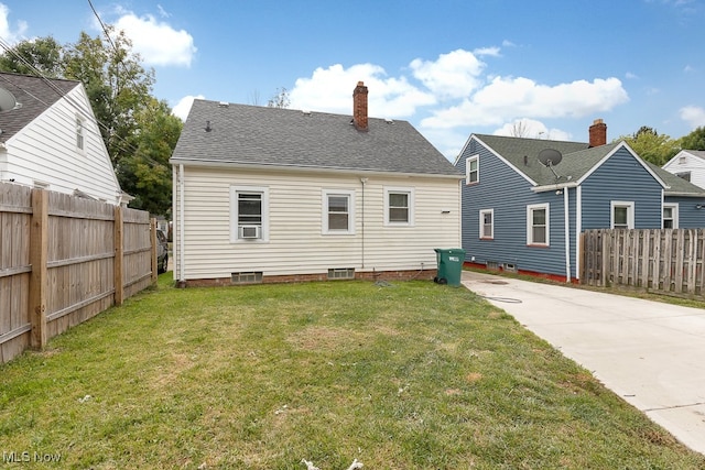 rear view of property with a yard and cooling unit