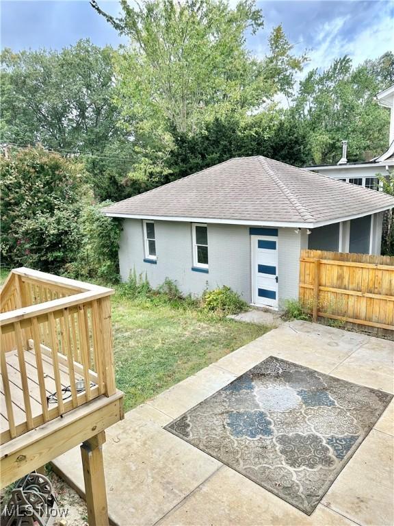 view of outbuilding with fence