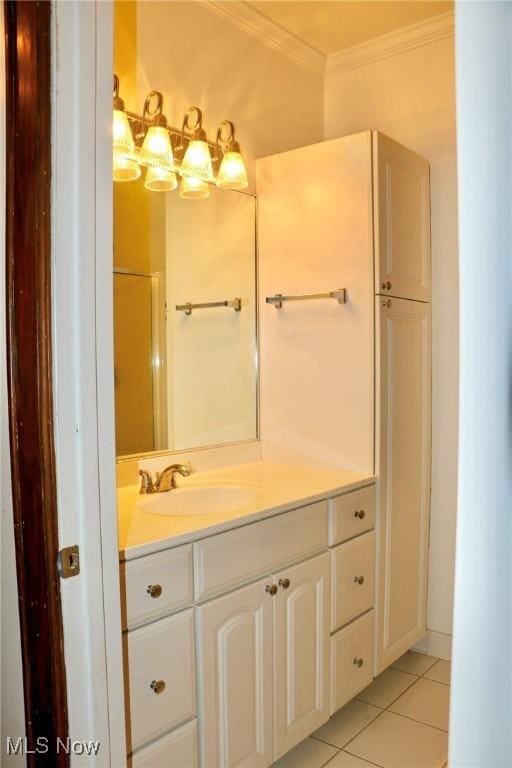 bathroom featuring tile patterned floors, vanity, and crown molding