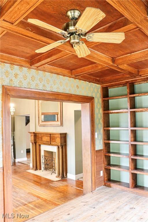 unfurnished living room with wooden ceiling, a ceiling fan, wallpapered walls, and light wood-type flooring