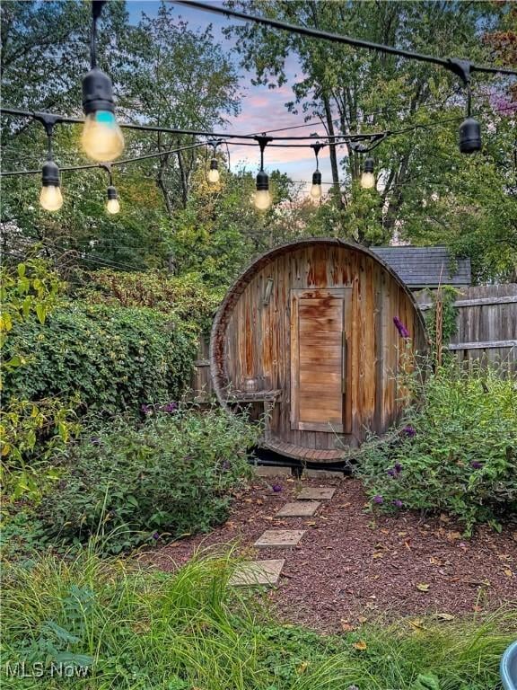view of shed with fence