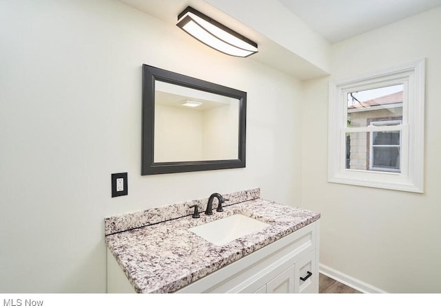 bathroom featuring hardwood / wood-style flooring and vanity