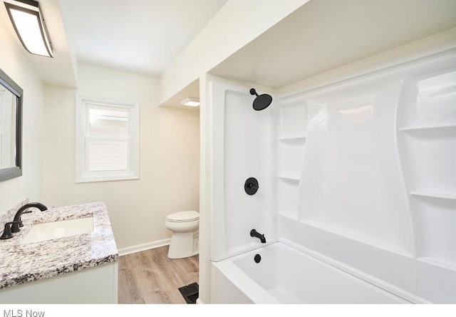 full bathroom with wood-type flooring, shower / tub combination, vanity, and toilet