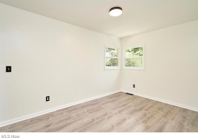 empty room with light hardwood / wood-style flooring