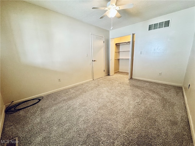 unfurnished bedroom featuring carpet, ceiling fan, and a closet