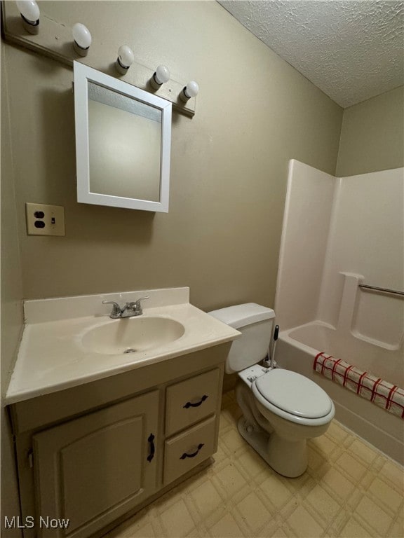 full bathroom featuring vanity, a textured ceiling, bathing tub / shower combination, and toilet