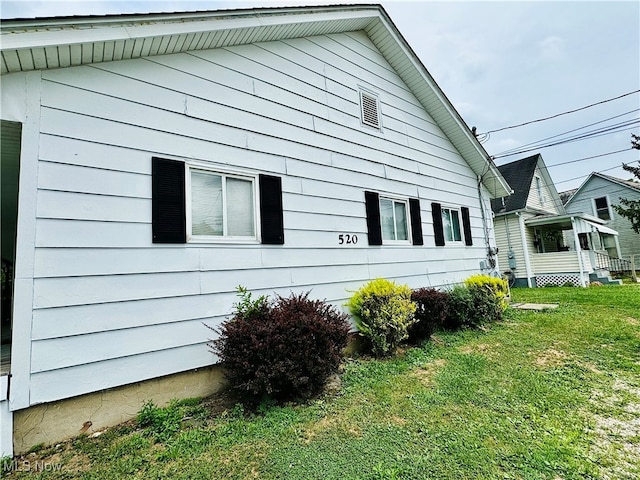 view of side of home with a lawn