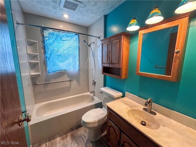 full bathroom with  shower combination, toilet, a textured ceiling, vanity, and hardwood / wood-style flooring