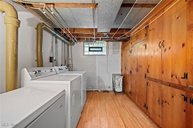 laundry area featuring washer and clothes dryer and light hardwood / wood-style flooring