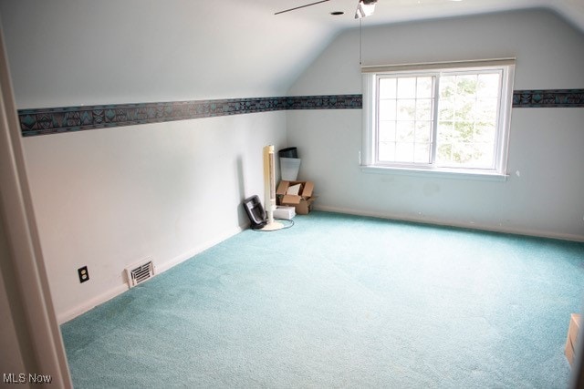 bonus room with ceiling fan, carpet flooring, and vaulted ceiling