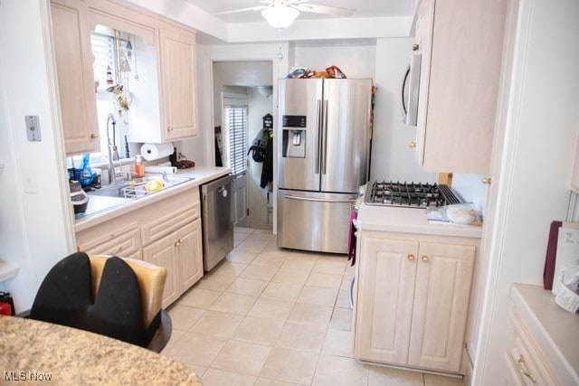 kitchen with ceiling fan, light tile patterned floors, appliances with stainless steel finishes, and sink