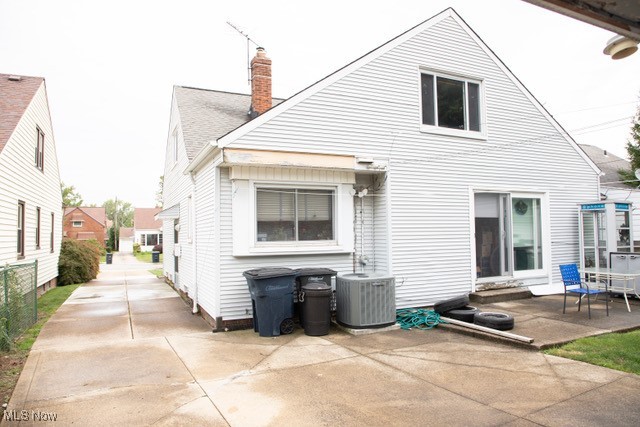 back of house with central AC and a patio