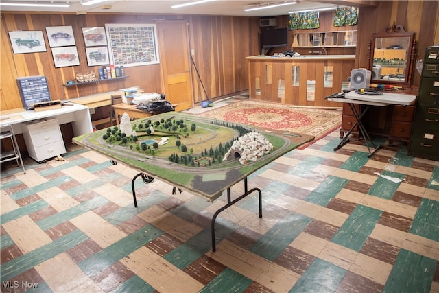 recreation room with wood walls