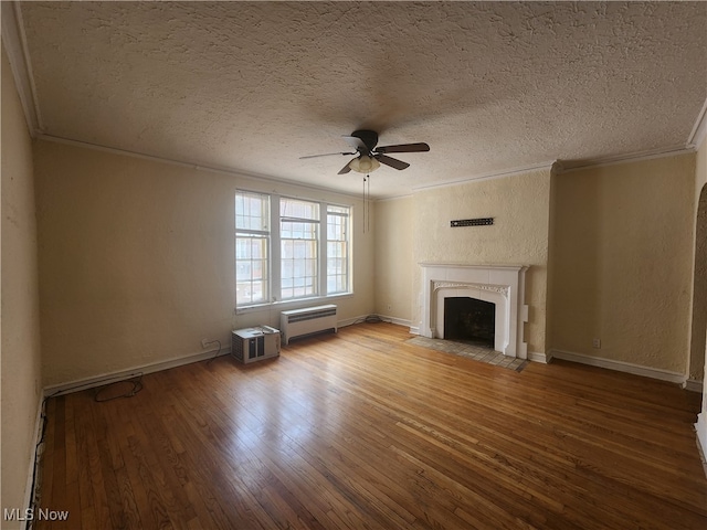 unfurnished living room featuring a textured ceiling, ornamental molding, hardwood / wood-style floors, and ceiling fan