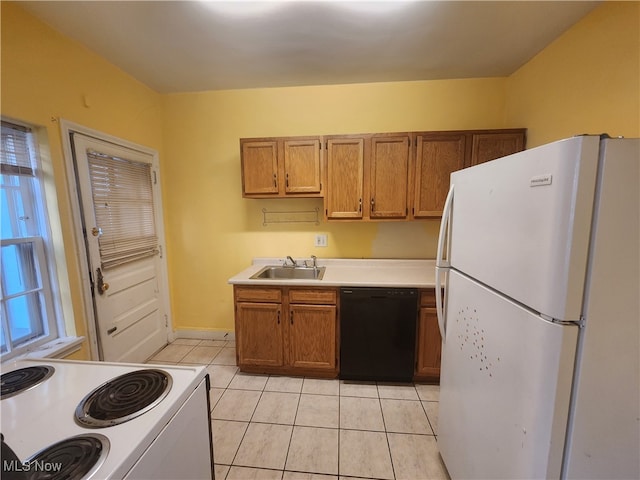 kitchen featuring white appliances, light tile patterned flooring, and sink