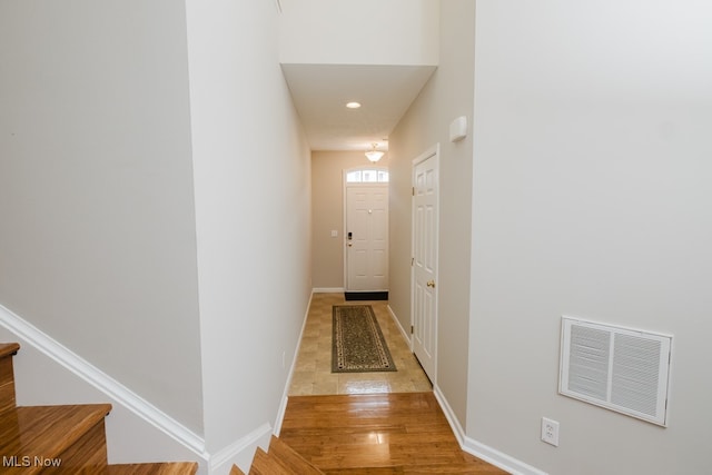 hallway with light hardwood / wood-style flooring