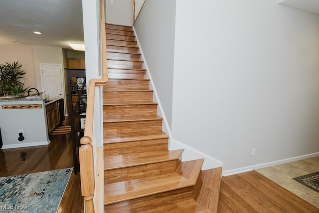 staircase featuring wood-type flooring