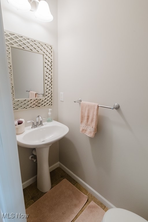 bathroom with tile patterned flooring and toilet