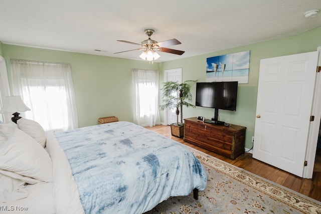 bedroom featuring ceiling fan and dark wood-type flooring