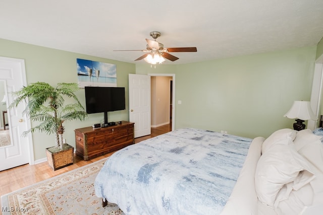 bedroom with wood-type flooring and ceiling fan