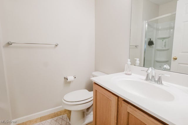 bathroom with vanity, tile patterned flooring, toilet, and an enclosed shower