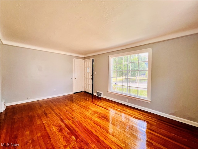 spare room with wood-type flooring