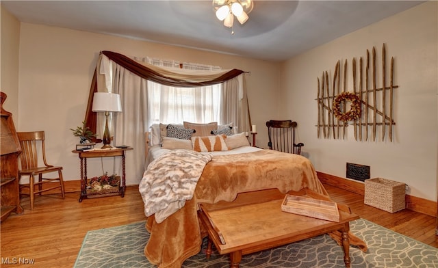 bedroom featuring ceiling fan and hardwood / wood-style flooring