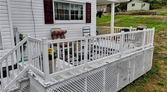 wooden deck with a lawn